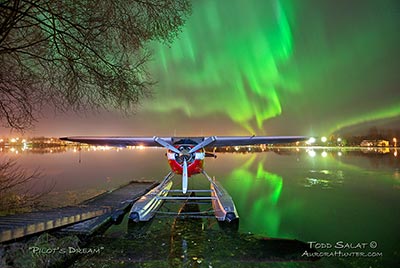  October 13, 2012 at 12:15 am. Lake Hood Seaplane Base, Anchorage. Cessna 195. Waves of auroras reflect on calm water.