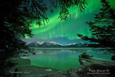 Green auroras whirl over Cook Inlet's Turnagain Arm just southeast of Anchorage, AK on January 6, 2015 at 11:55 pm.